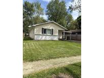 Charming single-story home with a lush lawn and a convenient carport at 346 Gimber Ct, Indianapolis, IN 46225