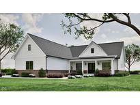 Charming single-story home boasts white siding, gray roof, brick foundation, and a welcoming covered porch at 3932 Besbie Way, Bargersville, IN 46106