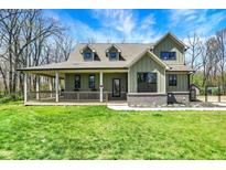 Charming home featuring a welcoming porch, dormer windows, and a well-manicured lawn at 5386 W 1100 N, Fountaintown, IN 46130