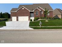 Charming brick home with a well-manicured lawn and an inviting entrance, plus a two-car garage at 5601 Harness Dr, Greenwood, IN 46143