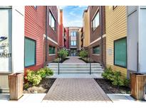 Charming condo complex with colorful siding, manicured landscaping, and a welcoming entrance at 622 E 10Th St # 312, Indianapolis, IN 46202