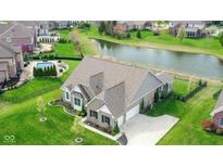 Stunning aerial view of the home, highlighting its spacious backyard and pond at 6784 W May Apple Dr, McCordsville, IN 46055