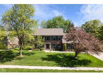 Charming two-story brick home with lush landscaping, mature trees, and a well-manicured lawn at 742 Marana Dr, Carmel, IN 46032