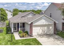 Charming single-story home featuring a two-car garage and inviting, landscaped front yard at 8141 Maple Stream Ln, Indianapolis, IN 46217