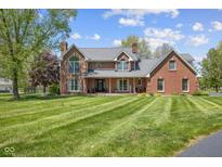 Expansive brick home with a large front lawn and manicured landscaping, inviting curb appeal at 10220 N Serenity Ln, Mooresville, IN 46158