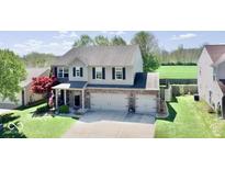 Charming two-story home with a well-manicured lawn, three-car garage, and beautiful curb appeal at 1234 Yellowstone Way, Franklin, IN 46131