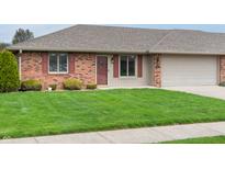 Charming brick home featuring a well-manicured lawn and attached one car garage at 126 Appian Way, Anderson, IN 46013