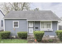 Charming single-story home with gray siding, trimmed hedges, and a well-maintained front yard at 1643 E Tabor St, Indianapolis, IN 46203