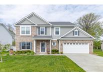 Charming two-story home with a well-manicured lawn and attached two car garage at 192 Lynnette Way, Cumberland, IN 46229