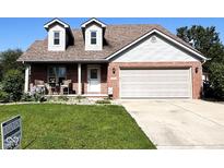 Charming brick home with a two-car garage and well-manicured lawn at 3085 Oakmont Dr, Lapel, IN 46051