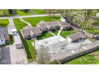 Charming single story home with a detached garage and a large concrete driveway perfect for multiple vehicles at 32 W Michigan St, Greenfield, IN 46140