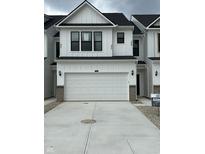 Modern two-story home with a white garage door and a concrete driveway at 3305 Noriker Ln, Zionsville, IN 46077