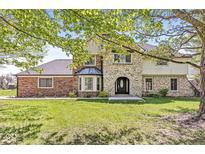Charming two-story home with stone and brick exterior and well-manicured lawn at 4152 S Creekside Dr, New Palestine, IN 46163