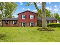 Charming two-story home with brick facade, black shutters, and a well-manicured lawn at 6123 W 46Th St, Indianapolis, IN 46254
