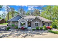 Beautiful brick home with stone accents and professionally landscaped front yard at 6149 W Olive Branch Rd, Greenwood, IN 46143