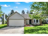 Charming single-story home boasts a well-manicured lawn and attached two-car garage, offering both curb appeal and convenience at 6257 Old Barn Ct, Indianapolis, IN 46268
