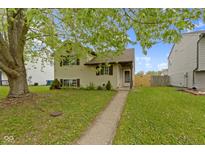 Charming two-story home featuring a well-maintained lawn and a welcoming walkway to the front door at 6638 Sunbury Dr, Indianapolis, IN 46241