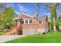 Charming brick home with a well-maintained yard, inviting entrance, and foundation at 7002 N Ralston Ave, Indianapolis, IN 46220