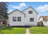 Charming two-story home boasts a well-maintained lawn and inviting curb appeal at 717 S A St, Elwood, IN 46036