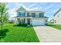 Charming two-story home featuring a well-manicured lawn, inviting entrance, and attached two-car garage at 745 S Summerhaven Ct, New Palestine, IN 46163