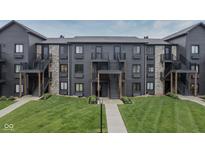 View of the exterior of a multi-Gathering building with stone accents and well-maintained landscaping at 102 Clarendon Dr # 506, Noblesville, IN 46062
