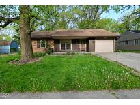 Charming single-story home featuring a lawn, attached garage, and inviting curb appeal at 112 Coronado Rd, Indianapolis, IN 46234