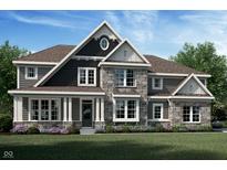 Charming two-story home featuring stone accents, large windows, and lush landscaping at 11857 Quiet Trace Ct, Fishers, IN 46037