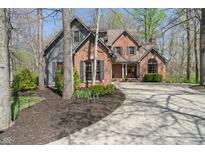Charming two-story home with brick and siding, complemented by a well-manicured front yard and winding driveway at 12608 E 86Th St, Indianapolis, IN 46236