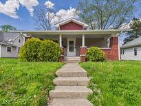 Charming craftsman-style home with a welcoming front porch and well-maintained lawn at 1408 W Jackson St, Muncie, IN 47303