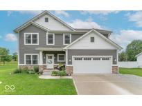 Charming two-story home with gray siding, white trim, and a well-manicured lawn at 1417 Layton Rd, Anderson, IN 46011