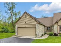 This home boasts a 2-car garage with a neutral door, stone accents, and manicured lawn at 15 Northridge Ct, Brownsburg, IN 46112