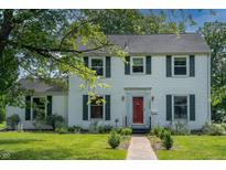 Charming two-story home featuring a red front door, symmetrical windows, and well-maintained landscaping at 2405 Sycamore St, Columbus, IN 47201
