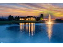 Stunning exterior view of a luxurious home reflecting beautifully in the tranquil pond at sunset at 2575 W 100 S, Franklin, IN 46131