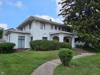 Attractive two-story home with a landscaped yard and a welcoming front porch at 302 E Main St, Greenfield, IN 46140