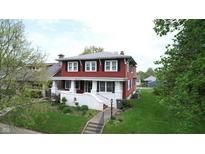 Charming two-story home featuring a cozy front porch and well-maintained landscaping at 319 N Ridgeview Dr, Indianapolis, IN 46219