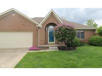 Charming brick home featuring a well-maintained lawn and colorful landscaping with an attached garage at 4652 Kensington N Way, Plainfield, IN 46168