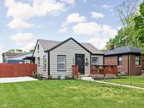 Charming single-story home with a landscaped front yard and inviting front porch at 4902 Kingsley Dr, Indianapolis, IN 46205