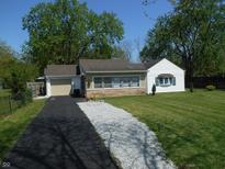 Charming single-story home with a stone accent wall and a well-maintained lawn at 4927 Mathews Ave, Indianapolis, IN 46227