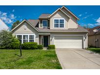 Charming two-story home with a well-maintained lawn and inviting curb appeal on a sunny day at 6472 Creekshore Ln, Indianapolis, IN 46268