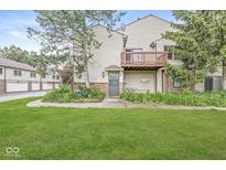 Charming backyard with a small patio and well-maintained lawn, perfect for outdoor enjoyment at 9553 Maple Way, Indianapolis, IN 46268