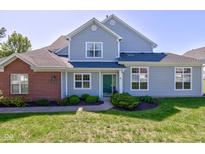 Charming two-story home with gray siding, brick accents, and well-maintained landscaping at 9602 Sweet Clover Way, Fishers, IN 46038