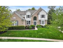 Charming two-story home with a well-manicured lawn and attractive landscaping at 9656 Loganberry Ln, Indianapolis, IN 46256