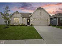 Charming single-story home with a well-manicured lawn, neutral brick, and an attached two-car garage at 9696 Parkhurst Xing, McCordsville, IN 46055
