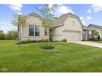 Beautiful single-story home with a well-manicured lawn, neutral brick, and an attached two-car garage at 9696 Parkhurst Xing, McCordsville, IN 46055