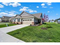 Beautiful single-Gathering home with manicured lawn, attached garage, and classic design elements under a bright sky at 15004 Stonneger St, Westfield, IN 46074