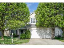 Charming two-story home featuring well-manicured landscaping and an attached two-car garage at 17060 Kingsbridge Blvd, Westfield, IN 46074
