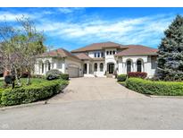 An impressive, light-colored, two-story home featuring a well-manicured front yard and an inviting circular driveway at 4726 Ellery Ln, Indianapolis, IN 46250