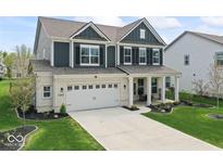 Beautiful two-story home with a well-manicured lawn, two car garage, and inviting front porch at 5363 Citadel Dr, Noblesville, IN 46062