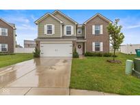 Charming two-story home featuring a manicured lawn, two car garage, and welcoming front porch at 5845 Cresswell Ln, Whitestown, IN 46075
