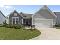 Charming home with a manicured lawn, gray siding, and a two-car garage at 6738 Fox Club Ln, Brownsburg, IN 46112